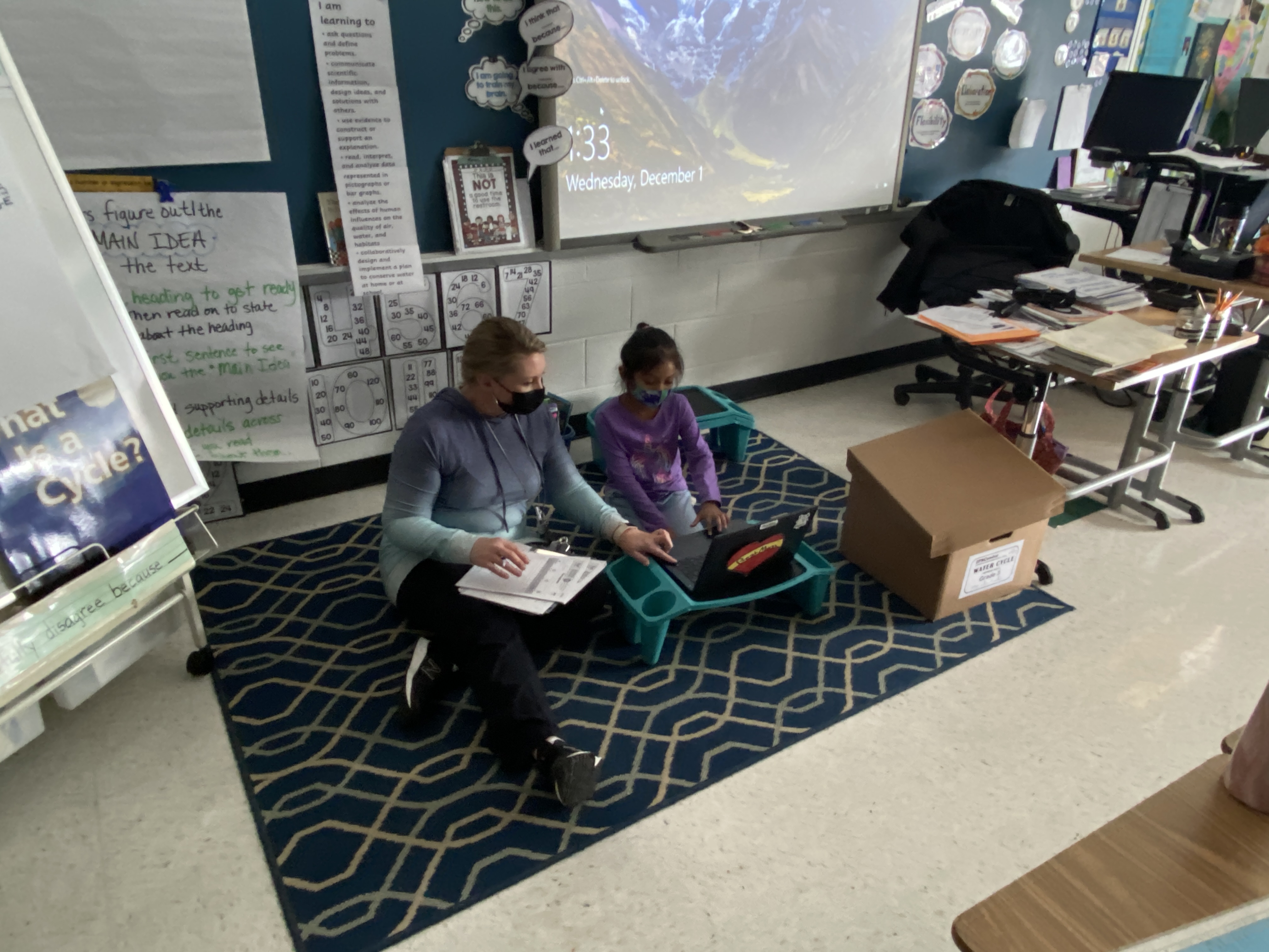 teacher and student on the floor reading