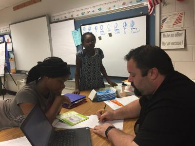 photo of teacher helping student