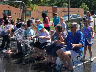photo of water being poured on seated teachers