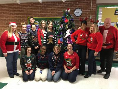 photo of teachers posing in ugly sweaters