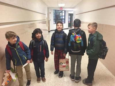 photo of students posing in the hall in their winter coats