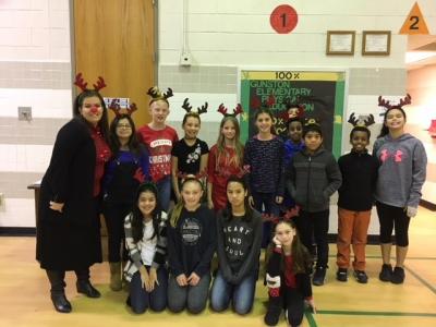 photo of students and teachers posing in reindeer headbands